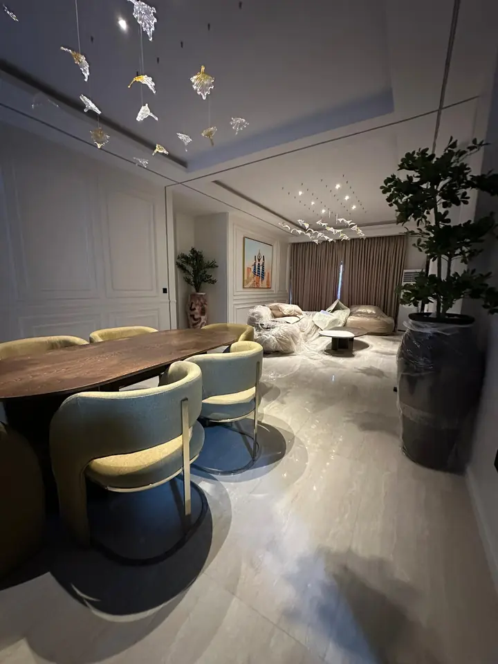 Dining table and living area under a tray ceiling with a suspended ceiling feature